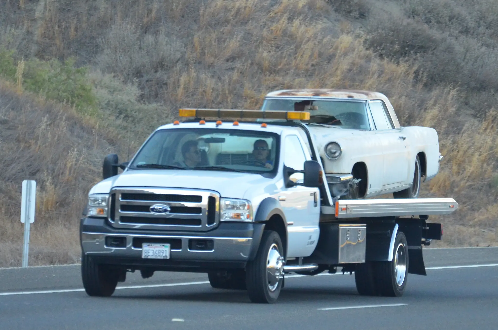 Flatbed Tow Truck Hauling A Classic Car