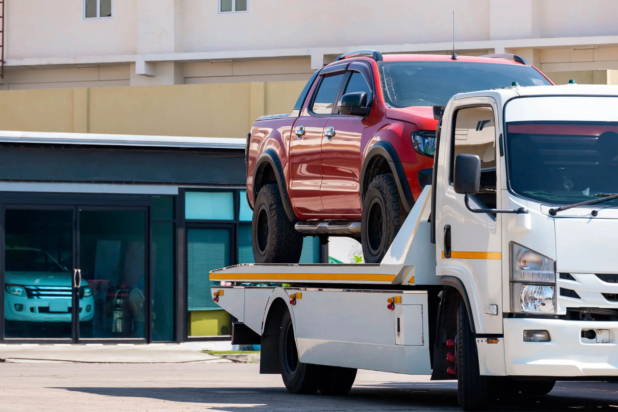 Broken red pickup car loaded onto white towing tru 2026 03 23 22 58 38 utc.jpg